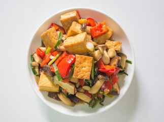 Stir Fried Tofu with Vegetables and Mushrooms on white background