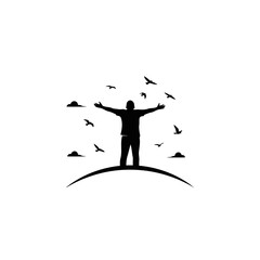 Vector art of silhouette of a man with arms outstretched on a hill with birds flying around a symbol of freedom