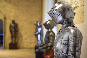 Close up side view of Medieval shiny Armor with details and armors in background