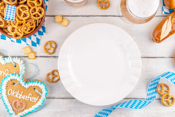 Oktoberfest holiday background with beer glasses, salted snack and pretzels