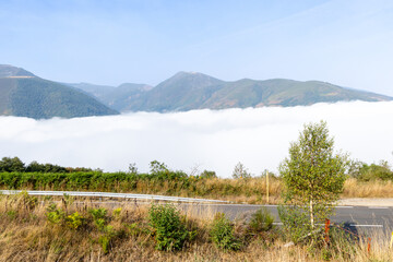 Leitariegos Pass, in Asturias, covered in fog with the mountains in the sun