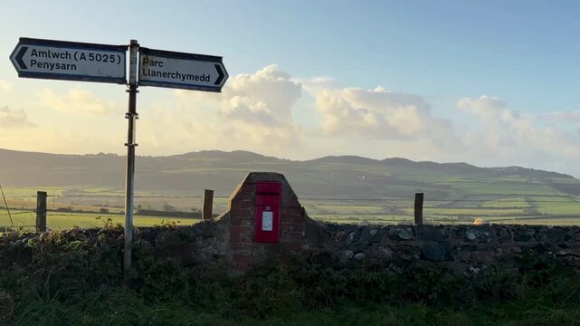 Time-Lapse of clouds moving over a rural landscape at sunrise near Llanerchymedd on the Isle of Anglesey in Gwynedd off the north Wales coast.