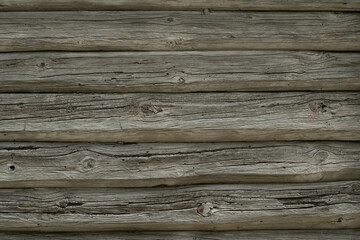 Old wooden log wall with natural texture.