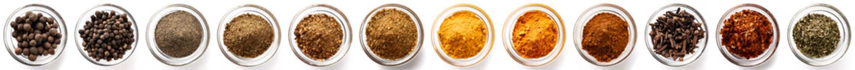 Collection of various colorful culinary spices in bowls, top view, isolated on white background