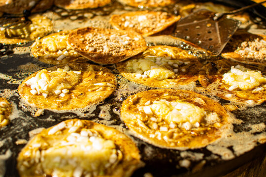 Cook frying delicious mexican memelas on september celebrations in Mexico