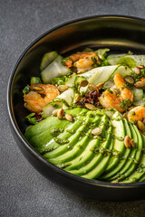 Fresh avocado and shrimp salad with cucumber and seeds