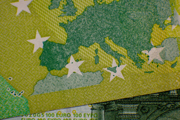 Map details of Europe on a 100 Euro banknote highlighting the stars of the European Union and intricate design features
