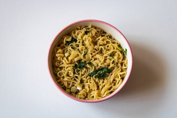 Bowl of instant noodles with herbs