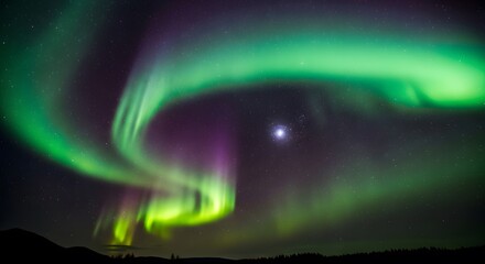 A spectacular display of the aurora borealis, with vibrant green and purple lights swirling across the dark night sky above a silhouetted treeline