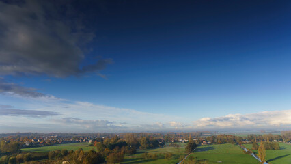 Obraz premium Breathtaking balcony view overlooking the lush green fields of Holland's countryside during a misty summer sunrise near Amsterdam, Netherlands