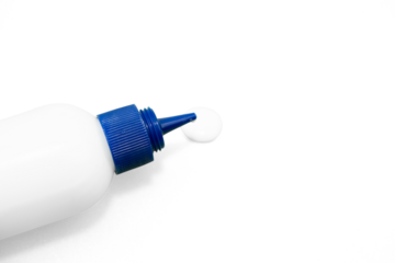 White glue bottle with blue cap dispensing a drop on textured surface close up  on a transparent Background