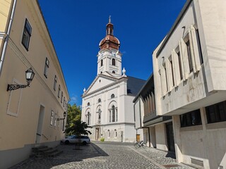 Obraz premium Historic church tower with white facade and red roof