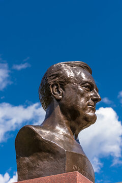 Hyde Park, NY - Bust of Franklin Roosevelt against brilliant blue sky and clouds at the Franklin D. Roosevelt National Historic Site. Perspective from below.