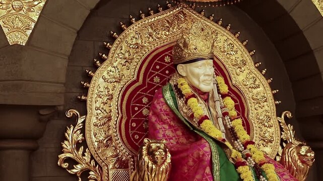 Sai Baba is seated peacefully in the temple, radiating a divine positive aura that fills the atmosphere with serenity and devotion