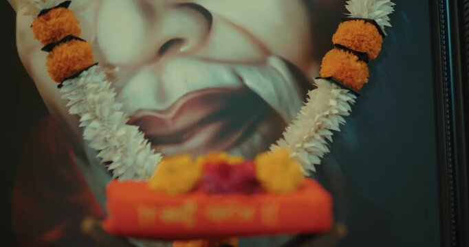 Devotees performing Sai Baba&rsquo;s puja with a small brass idol, lighting lamps, and offering fresh flowers, creating a serene and devotional atmosphere filled with faith and positive energy