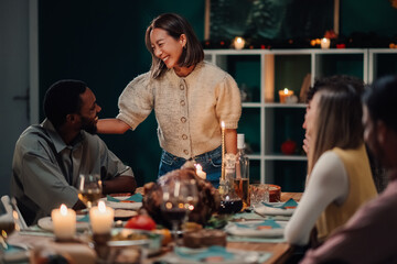 Friends enjoying thanksgiving dinner together at home