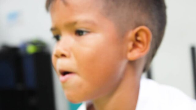 Portrait of a Latino soccer player in a white uniform training inside a gym in Neiva, Huila, Colombia. Childhood and sports concept