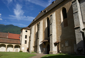  Historic stone church with tall columns and beautiful blue sky in the background, showcasing architectural details