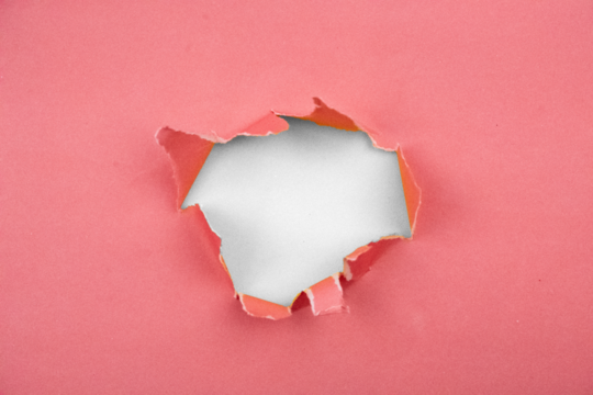 Torn pink paper reveals abstract black void for creative concepts and designs