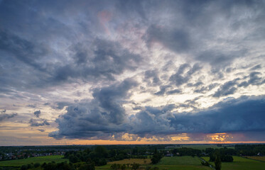 Breathtaking balcony view overlooking the lush green fields of Holland's countryside during a stormy summer sunset near Amsterdam, Netherlands