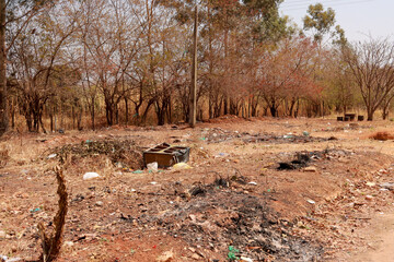 An empty lot that was used to dump trash and burn it 