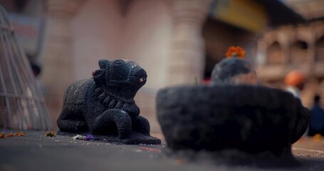 Stone idols of Shivalinga and Nandi surrounded by a devotional atmosphere, radiating deep spirituality and divine energy, reflecting the essence of Hindu culture and sacred traditions
