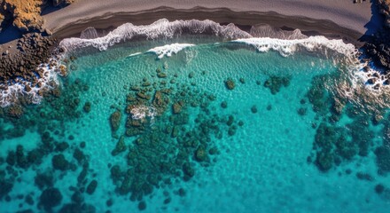 Crystal clear turquoise ocean waters reveal underwater coral reefs and rocky coastline