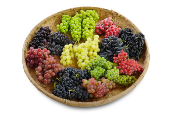 Assorted fresh grape varieties in a woven bamboo basket, featuring red, green, black, and elongated grapes on white background.