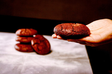 Hand holding red velvet cookie