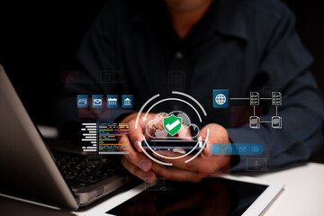 A person using a laptop with digital security icons overlay, emphasizing technology and cybersecurity.