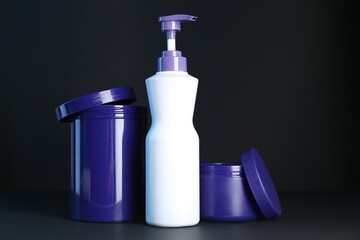 Different hair care cosmetic products for blonde hair on black background