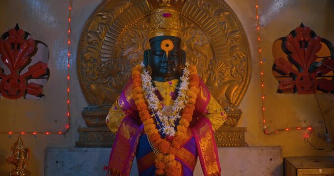 Sacred black stone idol of Lord Vitthal in the temple sanctum, radiating devotion and spirituality, symbolizing the essence of Hindu culture and divine faith