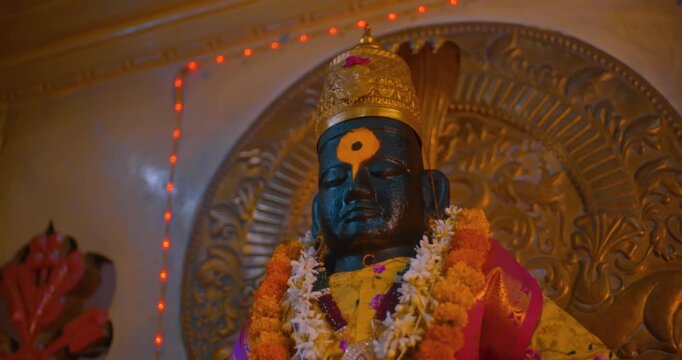 Sacred black stone idol of Lord Vitthal in the temple sanctum, radiating devotion and spirituality, symbolizing the essence of Hindu culture and divine faith
