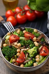 Delicious salad with shimeji mushrooms served on table, closeup