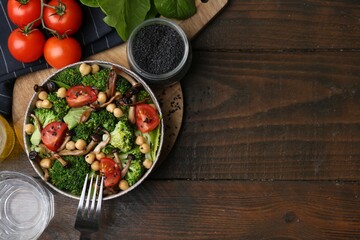 Delicious salad with shimeji mushrooms on wooden table, flat lay. Space for text