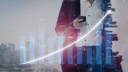 A businessman in a suit holds a smartphone while observing a financial graph overlay that illustrates growth, reflecting success in a modern urban setting. Copula