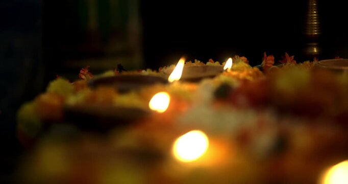 Decorative oil lamps in a Diwali puja thali and glowing diyas around the house, illuminating the home with festive light, devotion, and joy