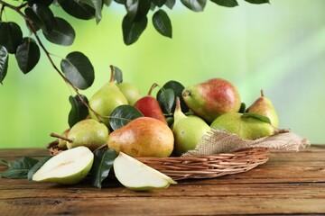 Fresh ripe pears with green leaves on wooden table