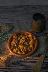 Beef stew with potatoes on a rustic table in warm light. Autumn food concept.