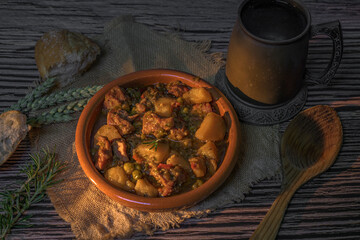 Beef stew with potatoes on a rustic table in warm light. Autumn food concept.