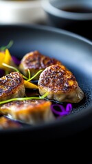 Savory dumplings garnished with vegetables on a black plate  