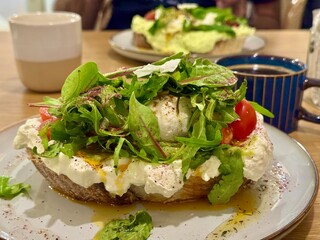 Creative brunch of eggs on the toast with salad