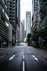 Fototapeta premium Empty asphalt road between modern buildings in singapore