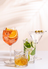 A vibrant display of cocktails, including Aperol Spritz, Mojito, and Martini