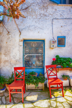 Fototapeta Narrow street in the old village of Afionas, surrounded by white architecture, on the Greek island of Corfu, background or wallpaper for a project