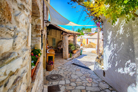 Fototapeta Narrow street in the old village of Afionas, surrounded by white architecture, on the Greek island of Corfu, background or wallpaper for a project