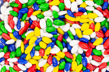 A pile of colorful candy with a variety of colors including red, yellow