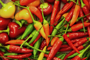 red peppers and yellow peppers are piled on top of each other