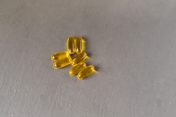 A pile of yellow pills on a counter