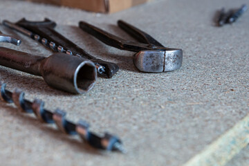 many different tools lie on a light surface close-up